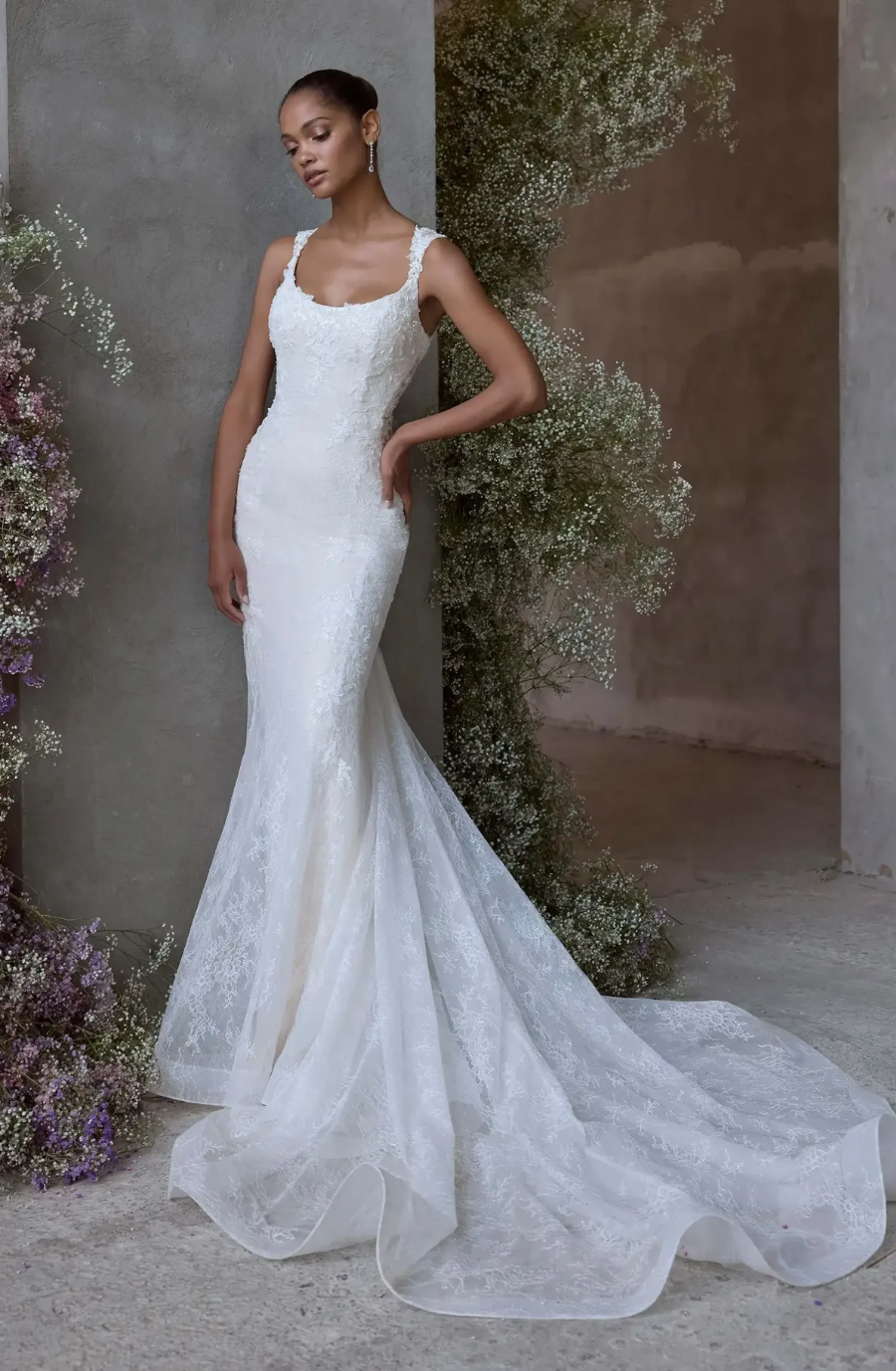 model is wearing a sleeveless fit and flare bridal gown