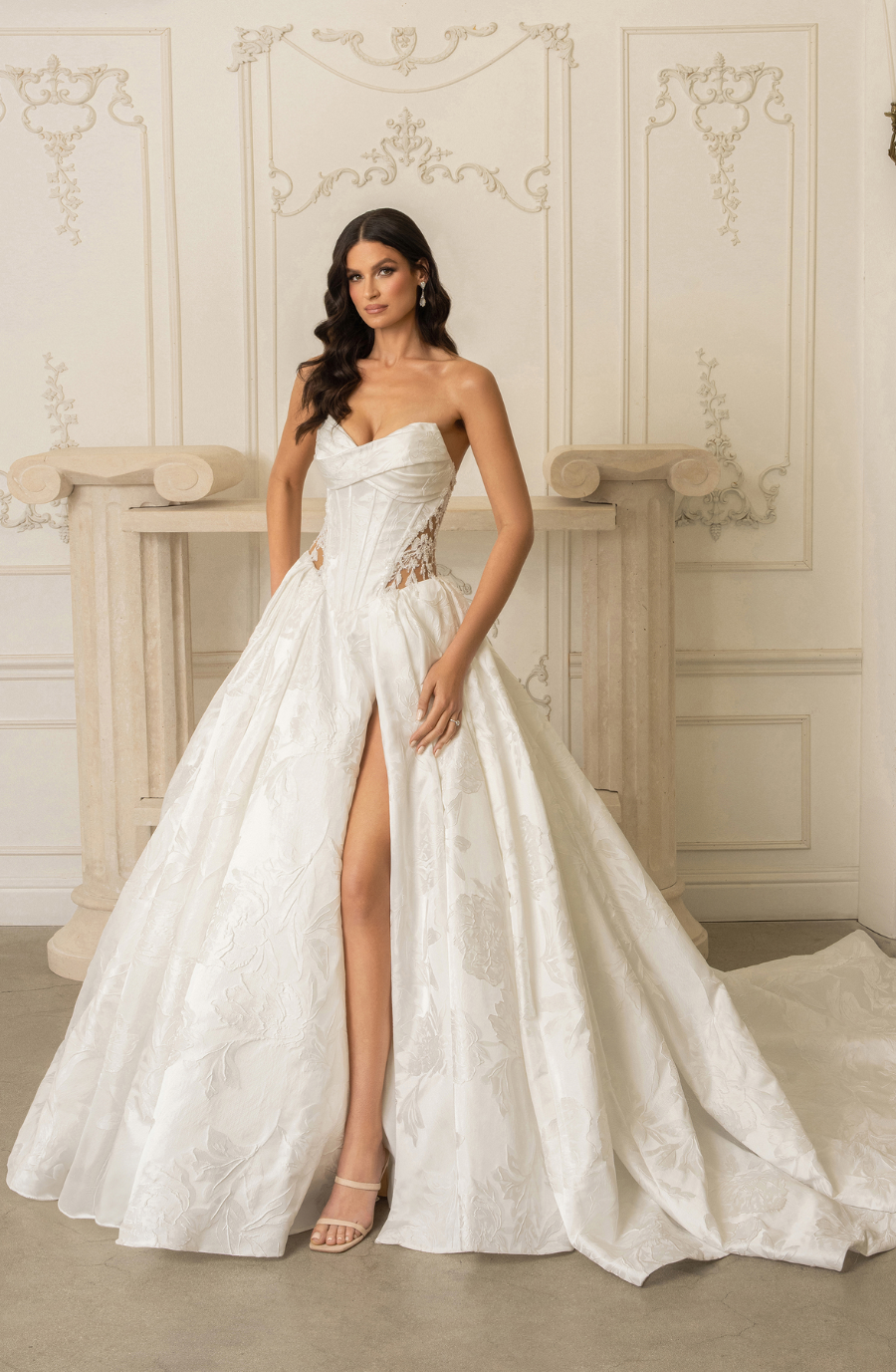 model is wearing a strapless ball gown