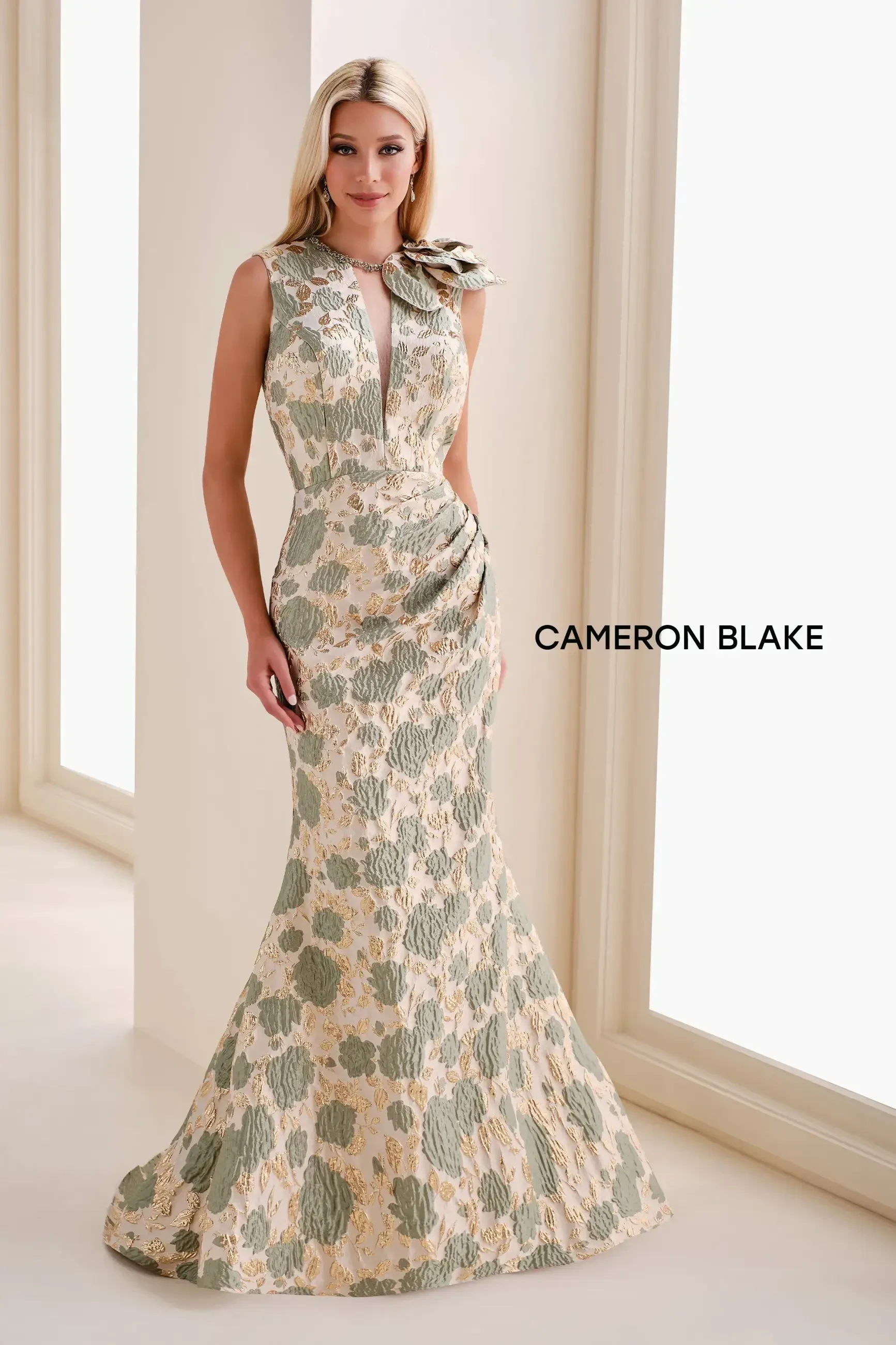 A woman wearing a floral patterned dress stands elegantly in a bright interior.