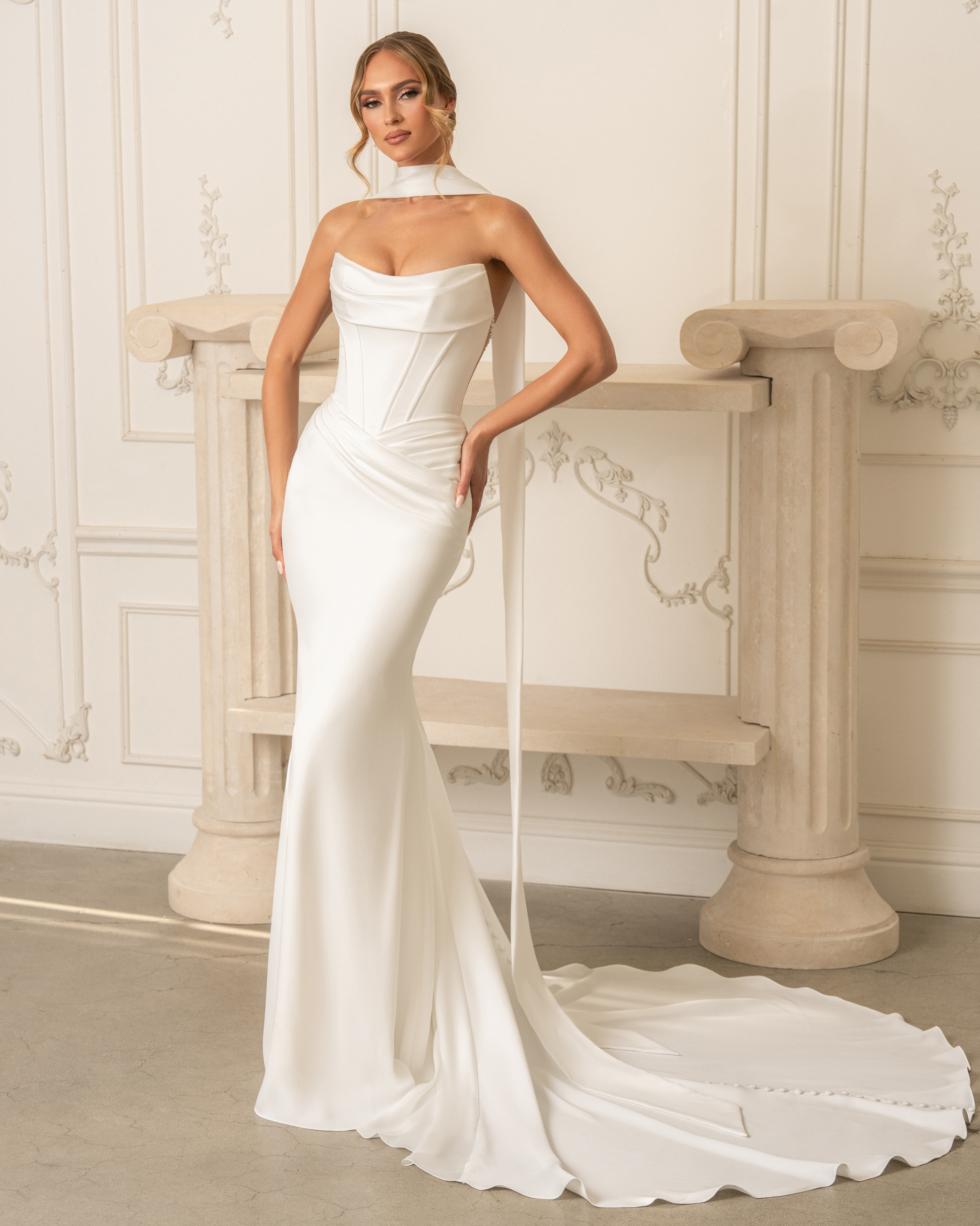 model is wearing a strapless fit and flare bridal gown