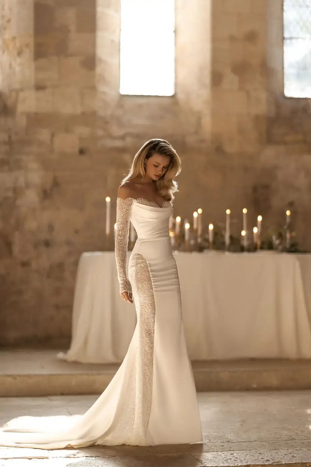 Model is wearing a satin mermaid wedding dress with long sleeves by wona concept